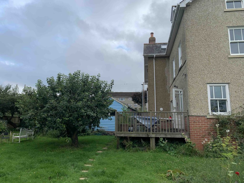 Existing rear elevation photo of property of a Swell Architecture single storey side extension in colyton devon.