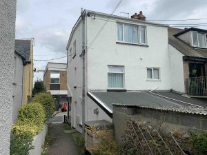 Existing site photo of rear elevation of Swell Architecture project for shop conversion into flat in Seaton Devon