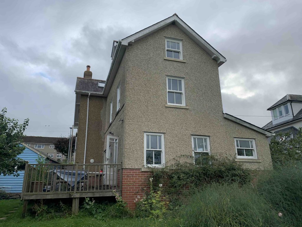 Existing whole rear elevation photo of property of a Swell Architecture single storey side extension in colyton devon.